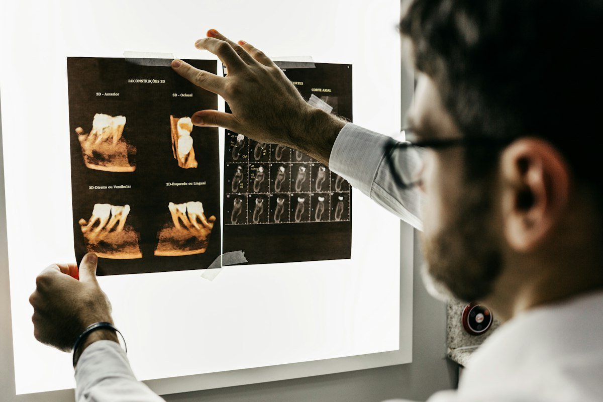 Private UK dentist reviewing 3D digital smile scan and treatment timeline with cosmetic patient on tablet