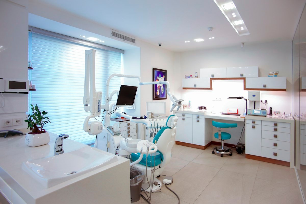 Modern British private dental practice featuring ergonomic patient chair, digital imaging equipment and sterilisation room