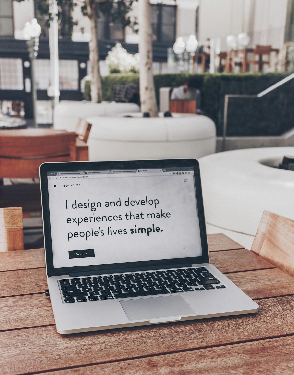 Web specialist designing clean responsive UI wireframes and high-conversion commercial page layouts on workstation